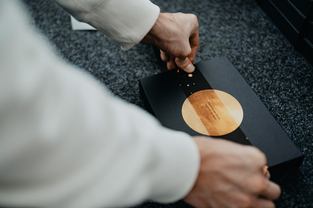 person holding brown wooden round plate