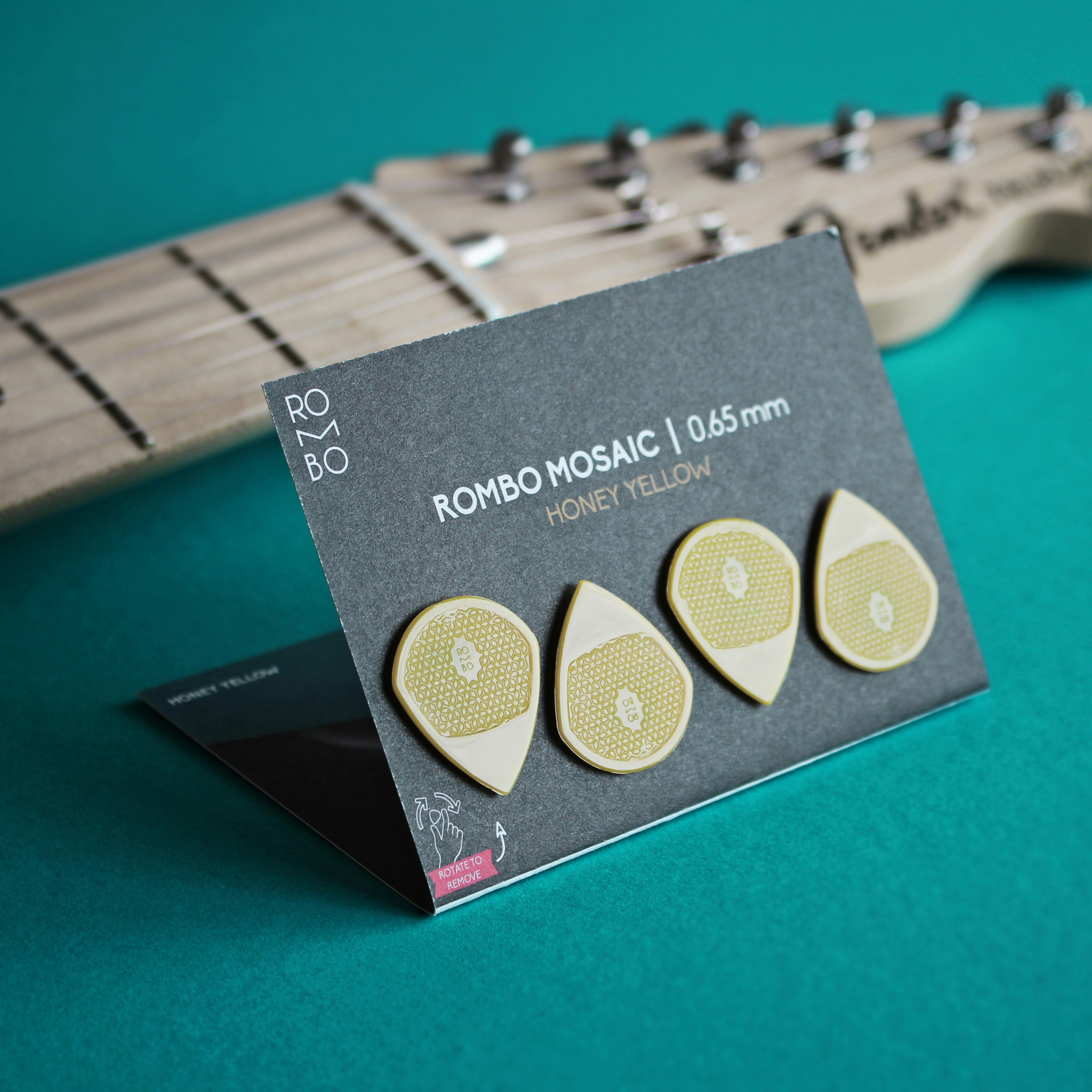 a set of three guitar picks sitting on top of a green table